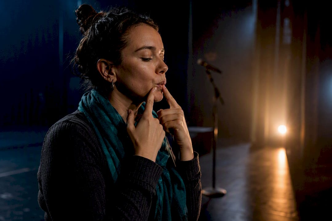 Singer performing gentle vocal warmup onstage